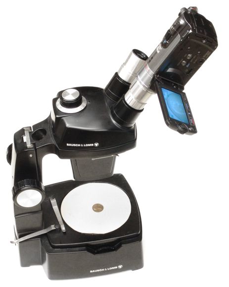 Canon HF200 video camera with 23mm eyetube adapter in use on a microscope binocular