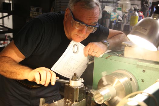 Richard Kinch cutting a microscope adapter on a metalworking lathe